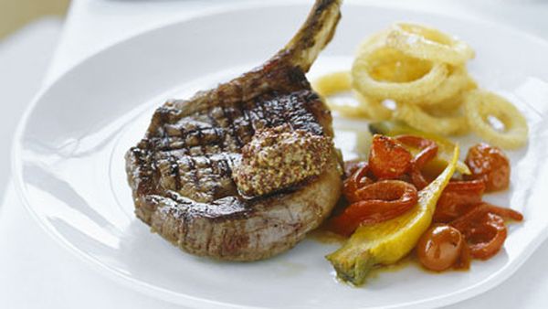 Rib-eye steak with cornmeal onion rings and charred tomato salad