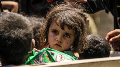 An Iraqi girl flees Mosul. (AFP)