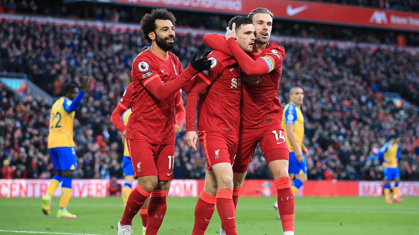 Mohamed Salah of Liverpool (L) and Jordan Henderson of Liverpool (R) celebrate with Andrew Robertson of Liverpool 