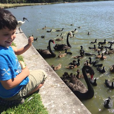 Jo Abi son feeding ducks