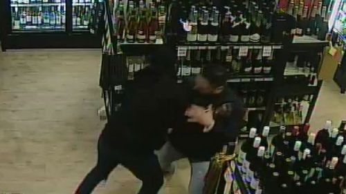 Mr Singh grapples with a would-be robber.