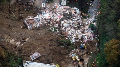 The three-story residential building was hit by the landslide just before 2.30am. (AAP)