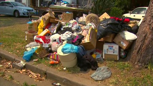 A Sydney hoarder was trapped for over 14 hours when the rubbish inside her home fell on top of her.