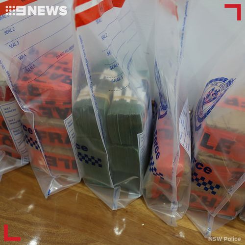 Four people have been charged after almost $6 million was allegedly found in the kitchen cupboards of a home in Sydney's southwest.