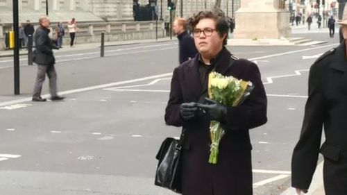 One man, whose friend was injured in the attack, visiting Westminster to leave flowers. (Reuters)