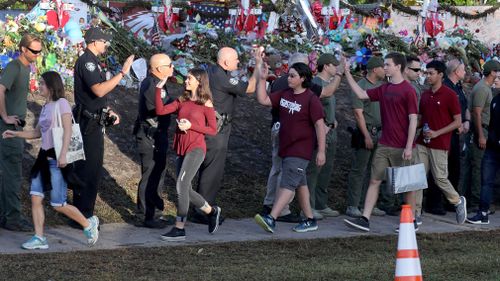 Students are greeted by law enforcement as they head back to school at Marjory Stoneman Douglas High School. (AAP)