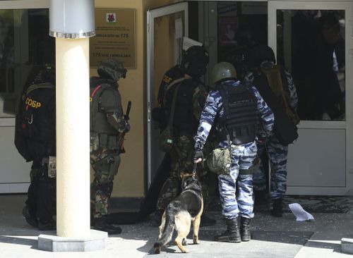 KAZAN, RUSSIA  MAY 11, 2021: FSB and special rapid response unit officers with a service dog enter school No 175 where two attackers opened fire; at least one teacher and eight students are reported dead. Yegor Aleyev/TASS (Photo by Yegor AleyevTASS via Getty Images)