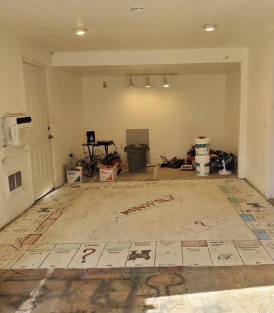 Couple find giant painted Monopoly board painted when they rip up carpet