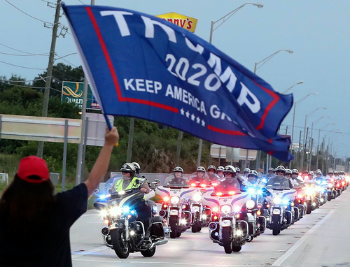 Protesters, most chanting Blue Lives Matter, yell and wave flags as the motorcade of Democratic Presidential nominee Joe Biden arrives at the Osceola Heritage Park in Kissimmee, Florida, on Tuesday, September 15, 2020.