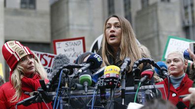 Dominique Huett, who says Harvey Weinstein sexually assaulted her, speaks at a press conference along with actresses Rosanna Arquette (L) and Rose McGowan (R) outside court on January 6, 2020 in New York City. 