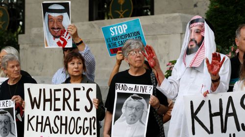 Protesters hold signs at the Embassy of Saudi Arabia in Washington.