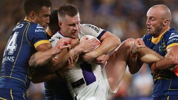 Cameron Munster of the Storm Is tackled by Jirah Momoisea and Josh Hodgson.