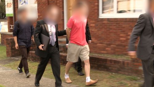 Australian Federal Police officers arrest a man during operation BYAHAUT. The 59-year-old Sydney man was allegedly acting as an economic agent for the North Korea. (AAP)