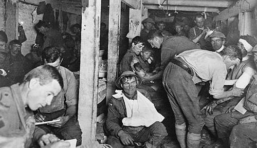 Wounded Australian soldiers receive treatment at a medical post during The Battle for the Menin Road in 1917. (Photo: Australian War Memorial).