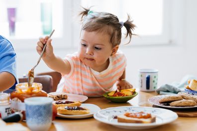 Happy toddler eating breakfast