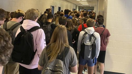 In this photo provided by student Hannah Watters, students crowd a hallway, Tuesday, Aug. 4, 2020, at North Paulding High School in Dallas, Georgia.