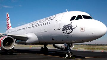 A Virgin passenger jet sits on the runway at Perth Airport.