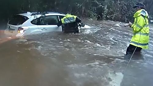 Police rescued a woman from a car in Kempsey, NSW in the floods.