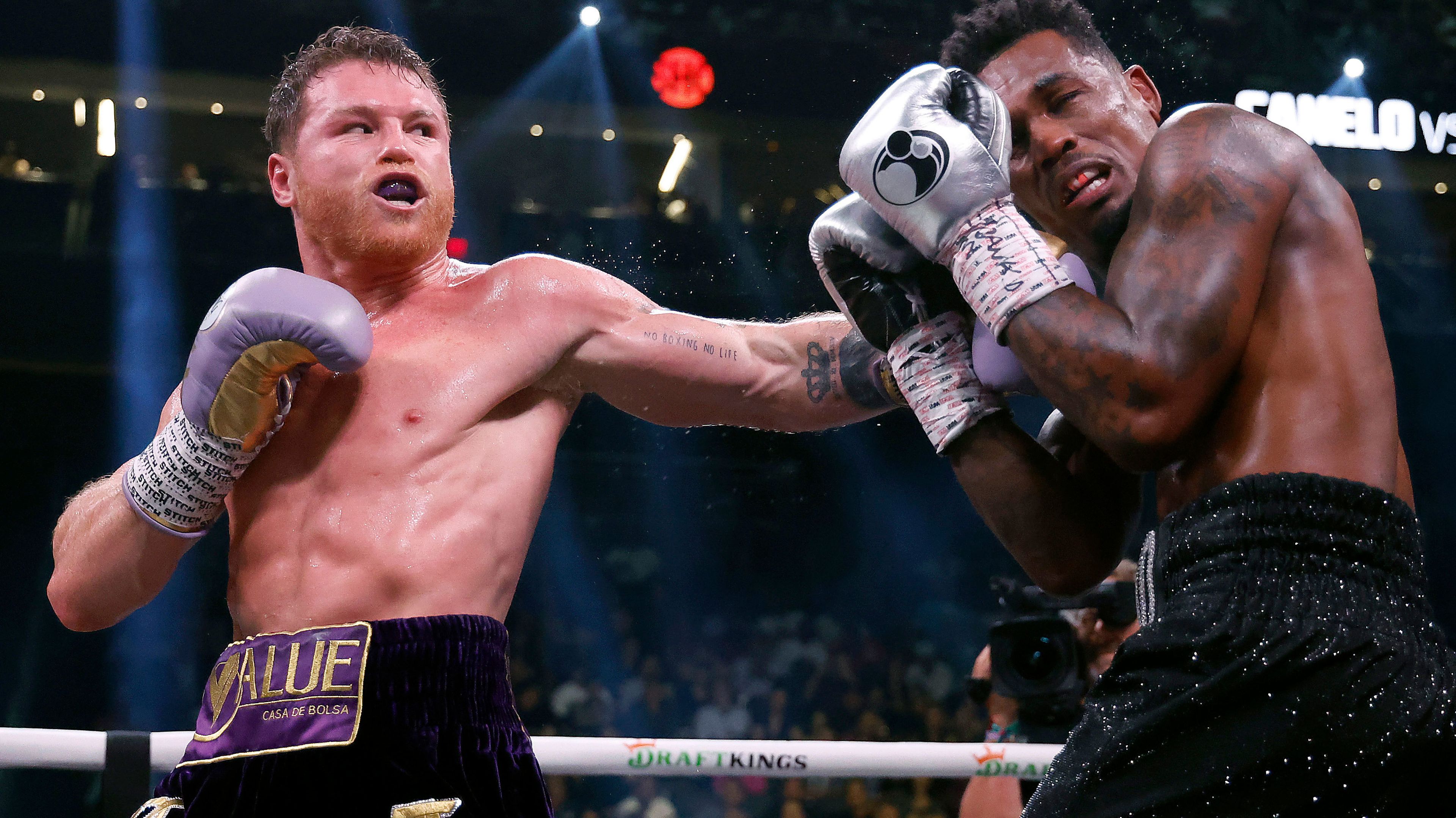 Saul &quot;Canelo&quot; Alvarez of Mexico trades punches with Jermell Charlo during their super middleweight title fight at T-Mobile Arena on September 30, 2023 in Las Vegas, Nevada.  