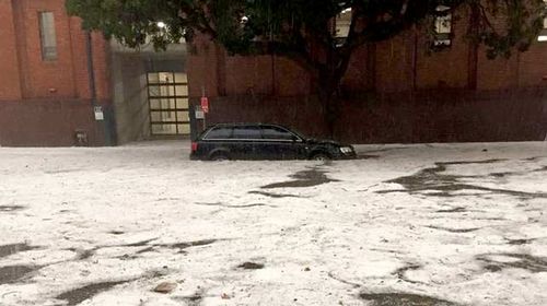 A 'river of snow' rushes down a street in Rosebery, Sydney. Photo: Nelson Lai