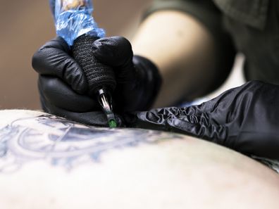 Tattoo artist doing their work