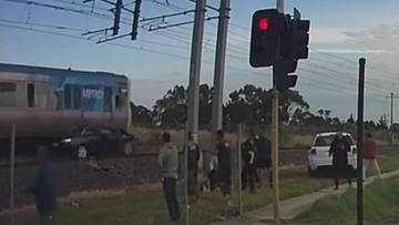 Vision of a car on the Melbourne train trucks being hit by a train