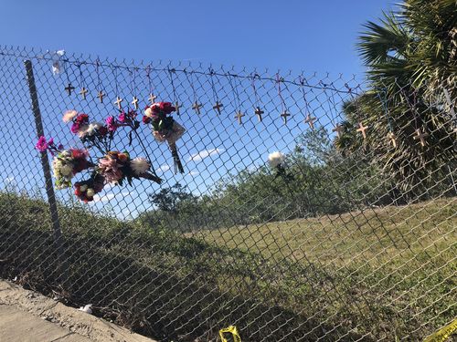 Flowers are tied to the school fence in tribute. Picture: Lizzie Pearl