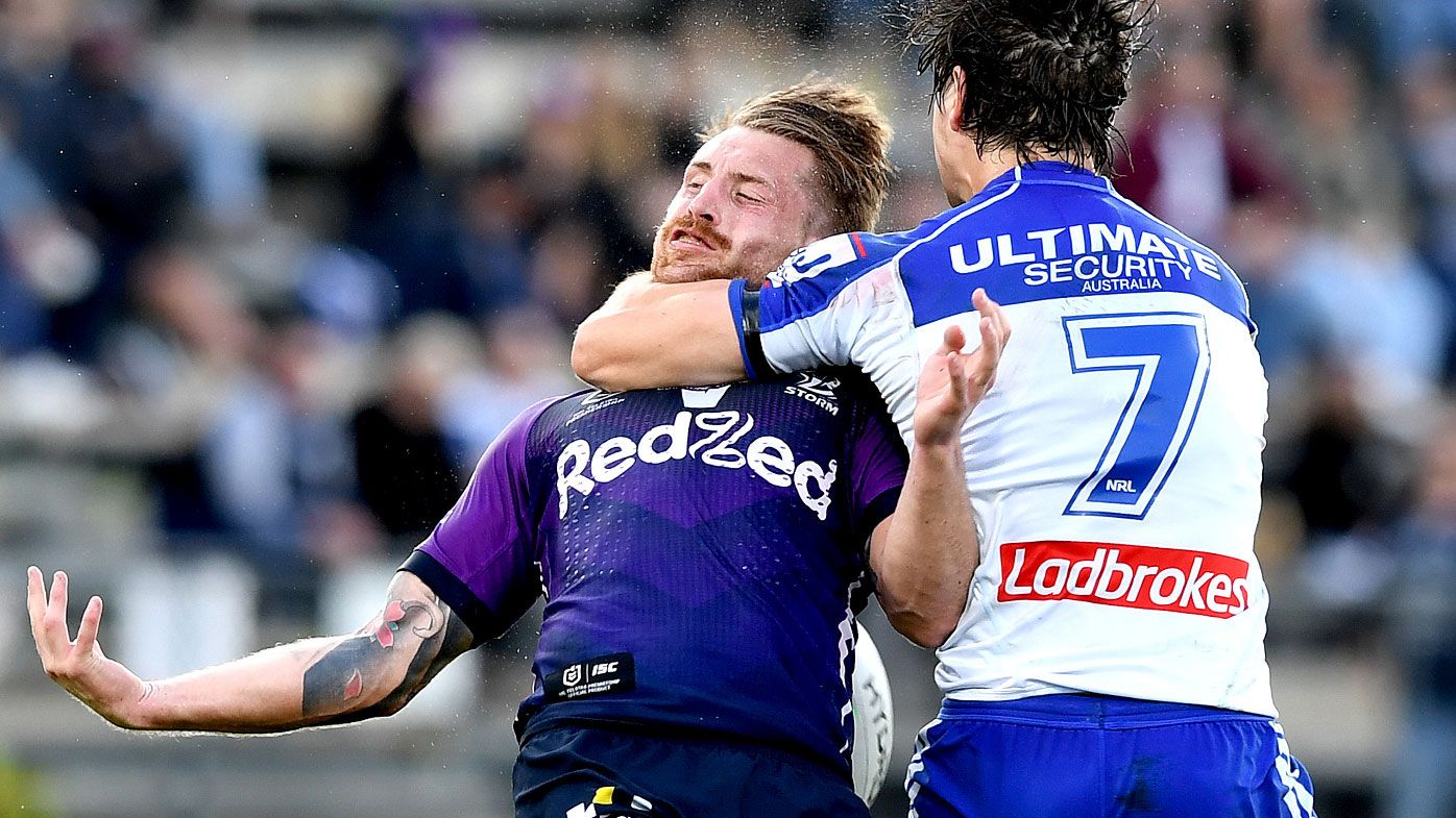  Cameron Munster of the Storm is hit high in the tackle by Lachlan Lewis of the Bulldogs 