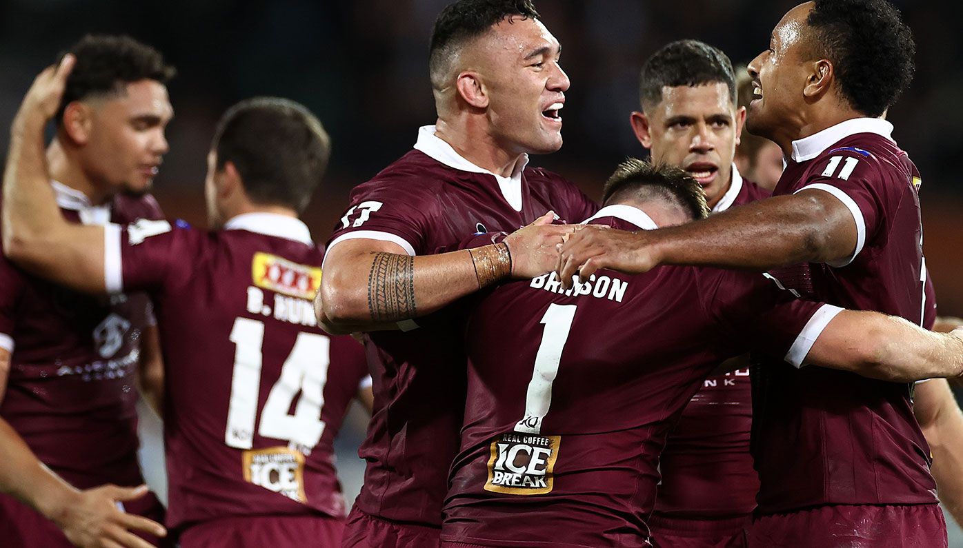 Queensland players celebrate after winning the opening State of Origin match against New South Wales.