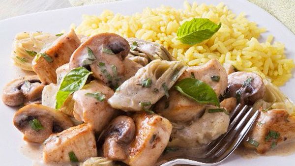 Creamy basil chicken with artichoke hearts, mushrooms and rice