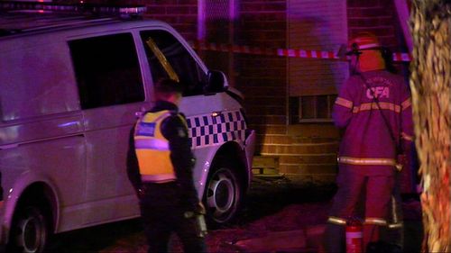 A police van crashed into the side of a house while responding to a house fire. Image: 9News