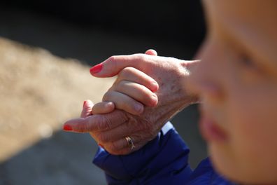 Woman walking with her grandson.