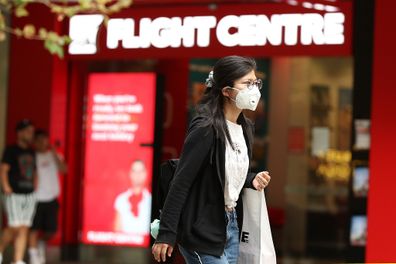 A woman is seen wearing a mask while walking down Murray Street mall on March 27, 2020 in Perth, Australia.