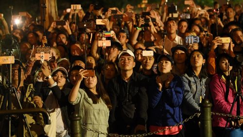 Tourists enjoy the midnight fireworks. (AAP)