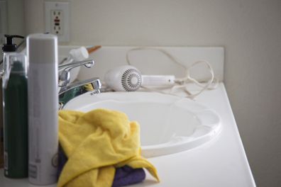 view of cluttered bathroom sink and counter