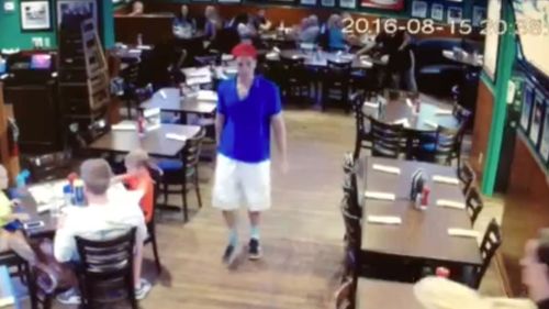 This image made from a video released Friday, August 19, 2016, by Duffy's Sports Grill, shows Austin Harrouff leaving the restaurant in Jupiter, Florida.
