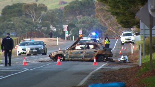 The burnt-out car.