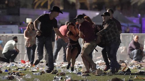 Festivalgoers are seen running from the event at the Mandalay Bay Resort and Casino. (Getty Images)