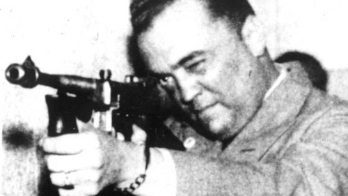 FBI Director J. Edgar Hoover aims a Thompson (or Tommy) gun. (AP)