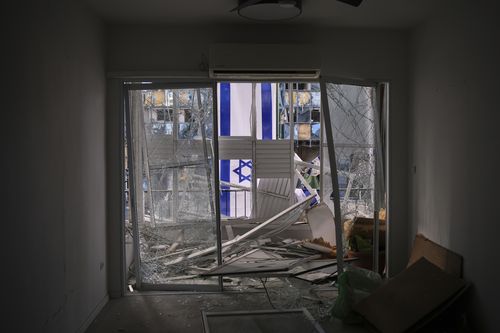 An Israeli flag is hung outside a damaged apartment two days after it was struck by a missile launched from Iran, in Ramat Gan, Israel, on Saturday, June 21, 2025. (AP Photo/Ohad Zwigenberg)