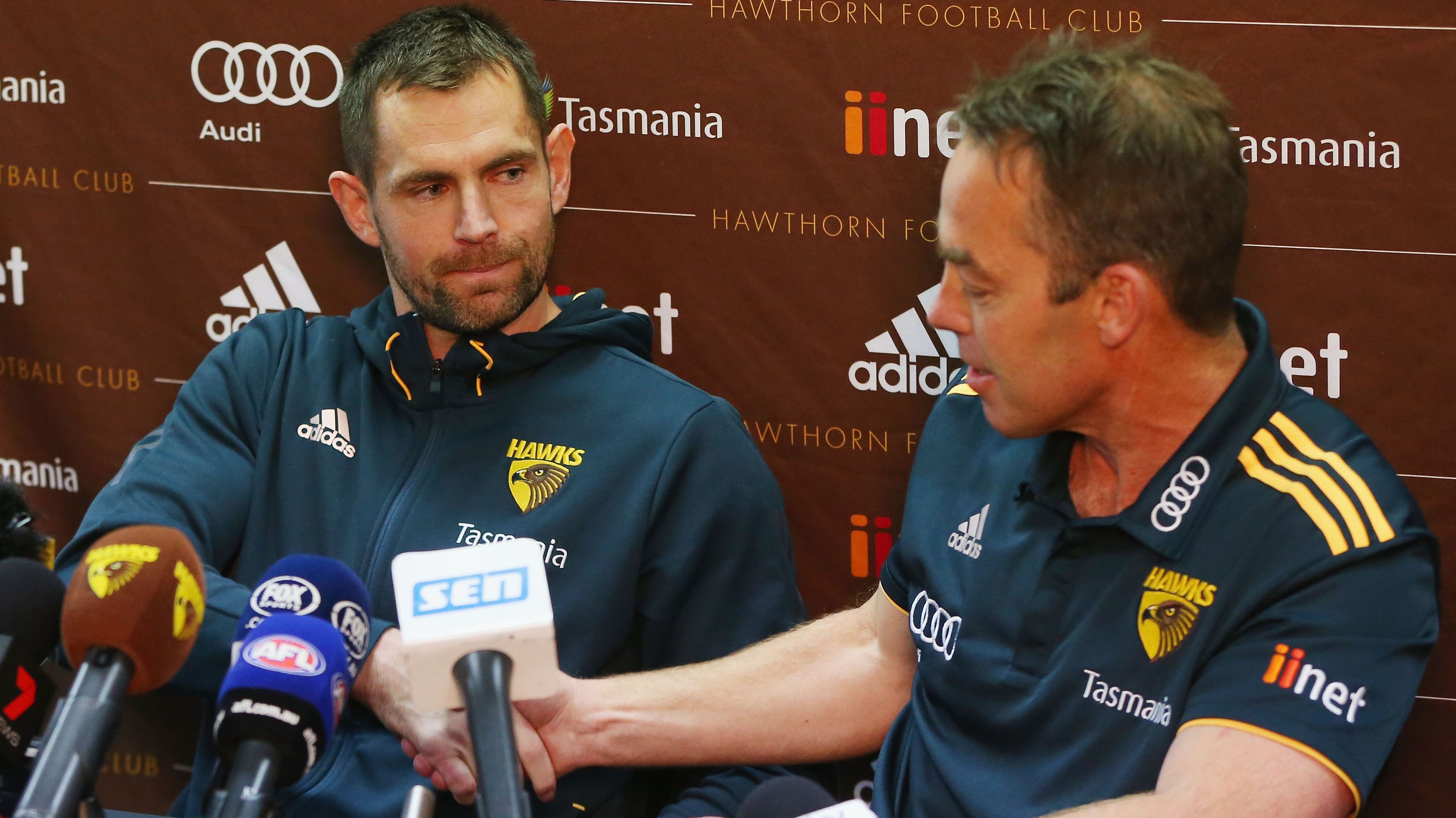 Luke Hodge speaks to the media during a Hawthorn press conference with senior coach Alastair Clarkson.