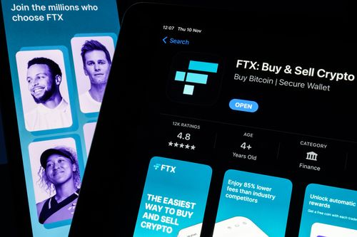 In this photo illustration the FTX logo and mobile app adverts are displayed on screens on November 10, 2022 in London, England. 