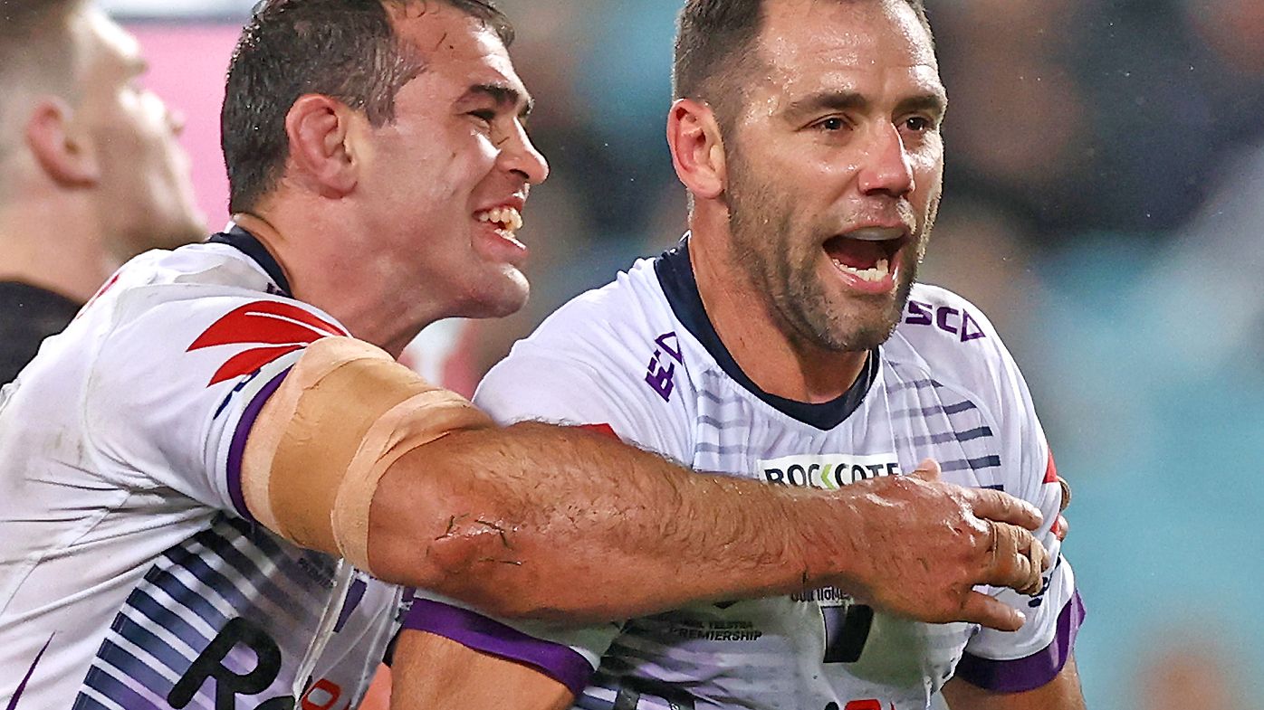 Cameron Smith of the Storm celebrates with team mates after scoring a try 