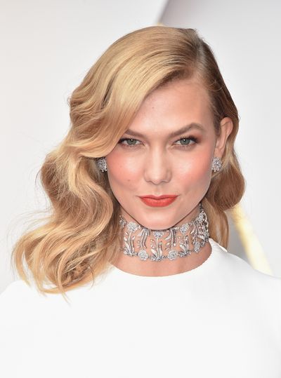 Karlie Kloss in classic true red lipstick teamed with Veronica Lake-style curls.