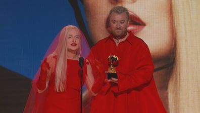 Kim Petras and Sam Smith accept Grammy award during 2023 ceremony.