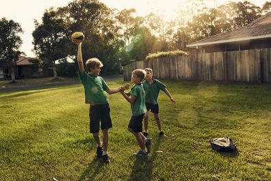 A group of boys playing with a football together