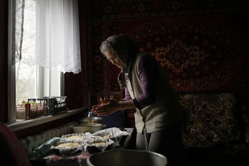 Olena Koptyl, 63, prepares dough to bake Ukrainian traditional Easter bread, called Paska, at her home on the outskirts of Chernihiv, northern Ukraine, Saturday, April 23, 2022. (AP Photo/Francisco Seco)