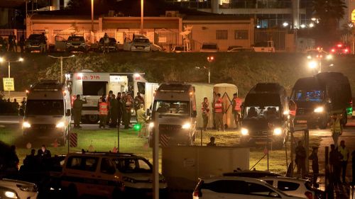 Israeli security forces stand next to ambulances waiting outside the helipad of Tel Aviv's Schneider medical centre on November 24, 2023, amid preparations for the release of Israeli hostages held by Hamas in Gaza.