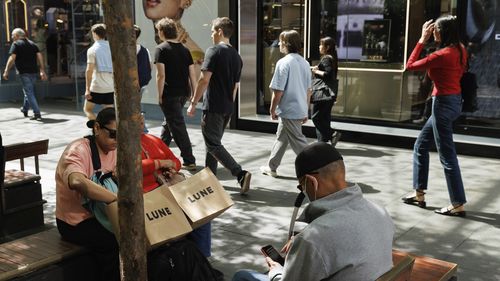 Gli acquirenti si siedono per riposarsi nel Pitt St Mall nel CBD di Sydney.