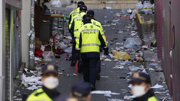 Police officers work at the scene of the fatal crowd surge, in Seoul, South Korea.